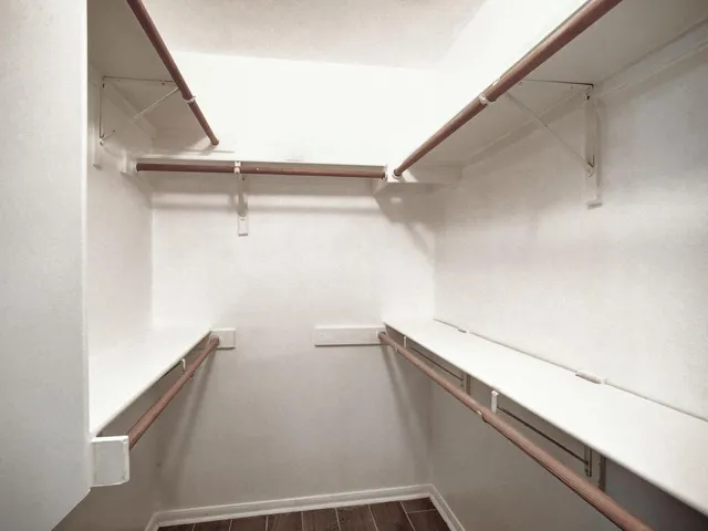 a view of a bedroom with wooden floor and bedroom