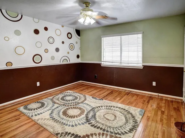 an empty room with wooden floor and a window