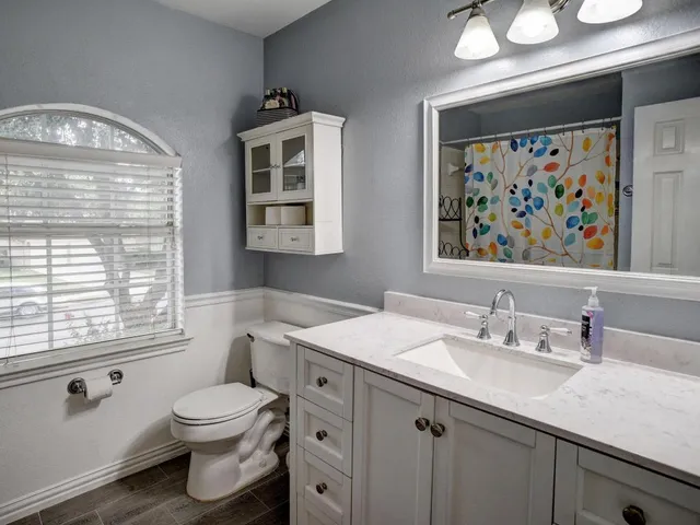 a view of a chair and table in backyard of the house