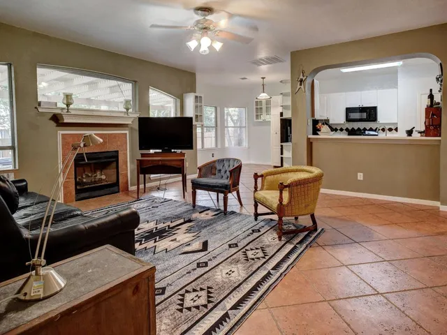 a living room with stainless steel appliances kitchen island granite countertop furniture and a large window