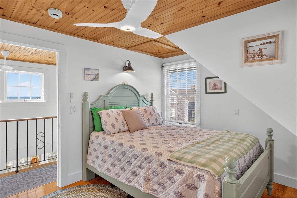 1145 Kingsbury Beach Road Eastham, MA 02642 - Photo 31 of 42 a bedroom with a large bed and a window
