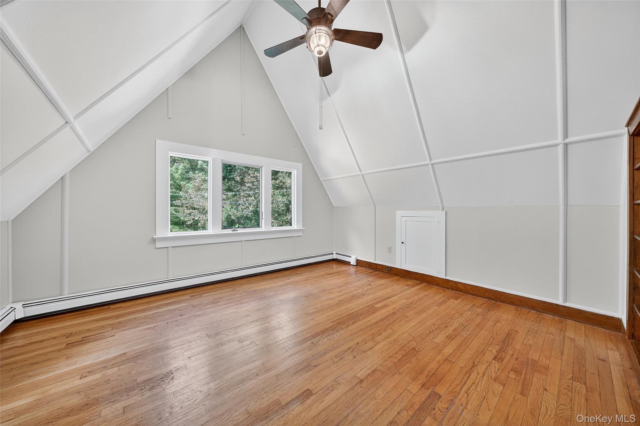 91 Sleepy Valley Road Warwick, NY 10990 - Photo 23 of 30 an empty room with wooden floor fan and windows