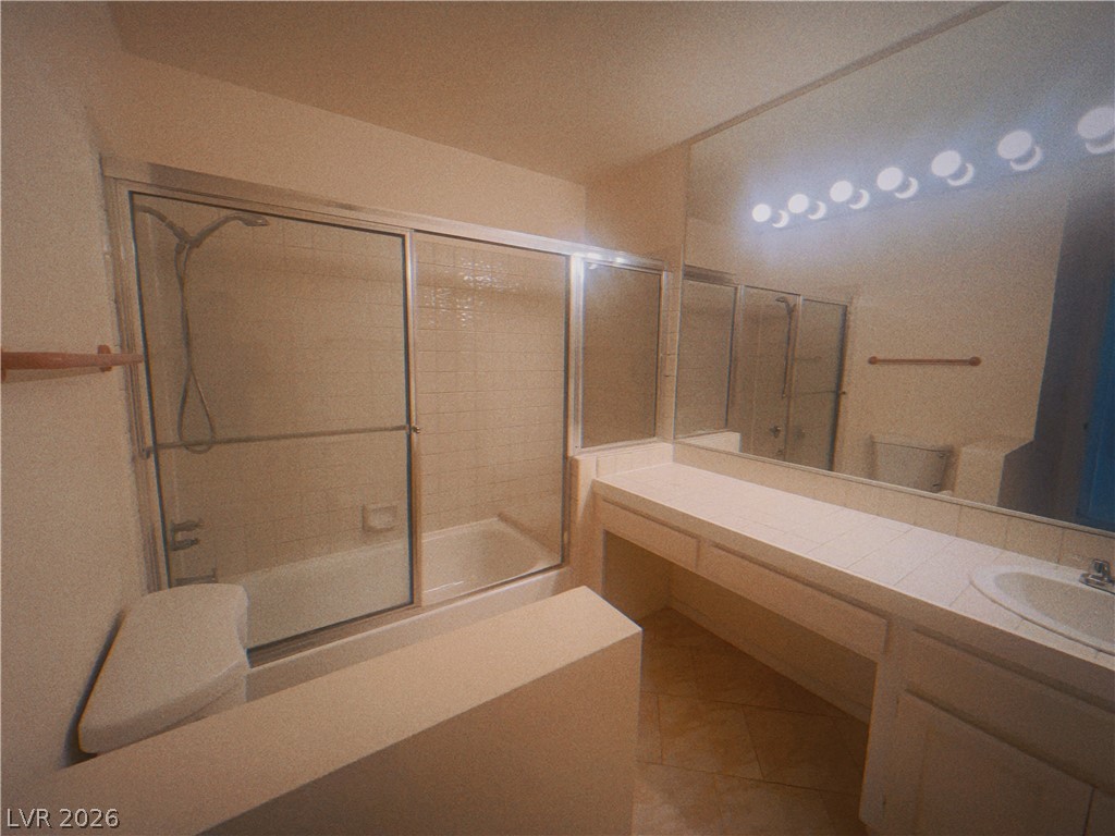 6250 West Flamingo Road, Unit 60 Las Vegas, NV 89103 - Photo 10 of 23 This bathroom features a shower and tub combination, a vanity with a single sink, and a spacious mirror.