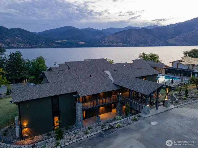 a view of a house with a yard and mountain view