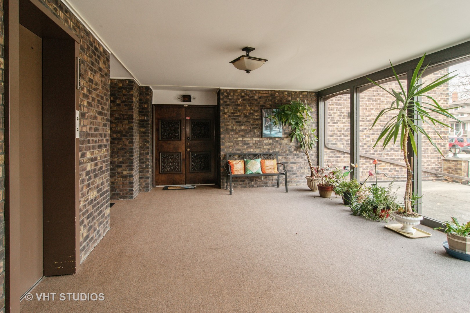 475 Shenstone Road, Unit 102 Riverside, IL 60546 - Photo 2 of 15 a view of a room with gym equipment and a large window