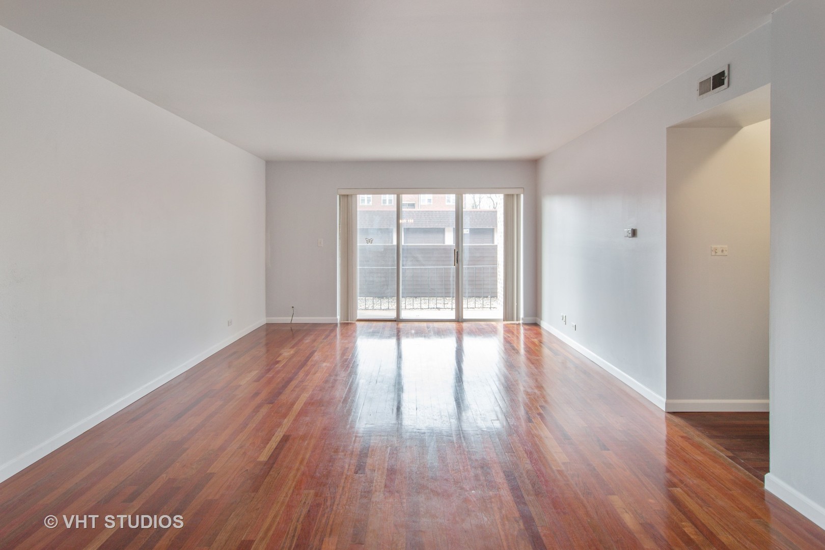 475 Shenstone Road, Unit 102 Riverside, IL 60546 - Photo 3 of 15 a view of an empty room with wooden floor and a window