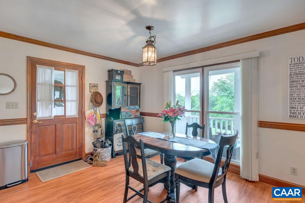 454 Pine Bluff Road Ruckersville, VA 22968 - Photo 13 of 69 a view of a dining room with furniture window and wooden floor