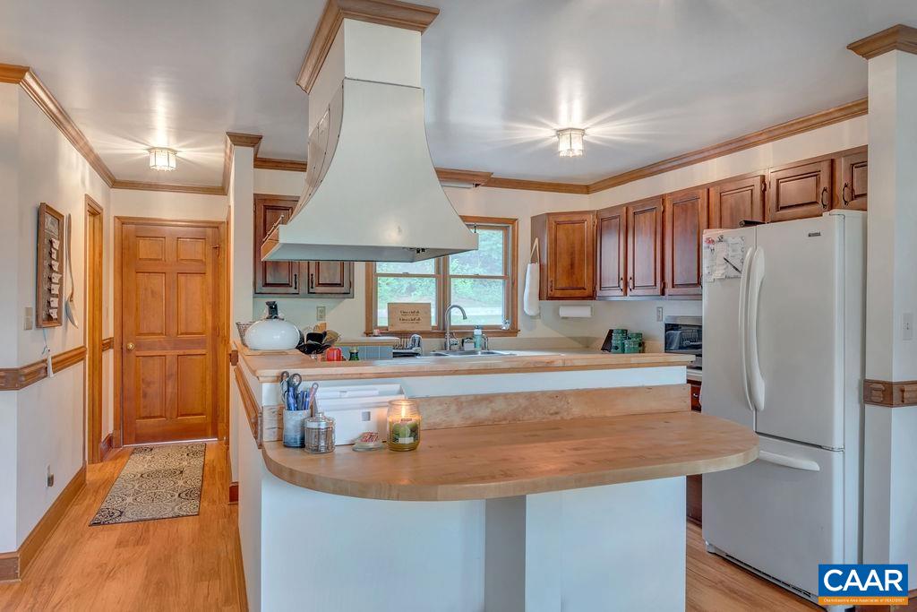 454 Pine Bluff Road Ruckersville, VA 22968 - Photo 14 of 69 a kitchen with stainless steel appliances granite countertop a refrigerator a sink and a stove
