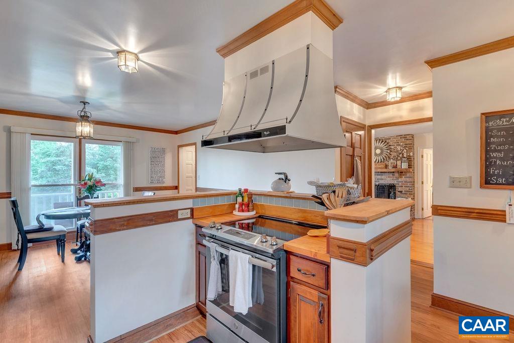 454 Pine Bluff Road Ruckersville, VA 22968 - Photo 16 of 69 a kitchen with stainless steel appliances granite countertop a sink a stove and a refrigerator