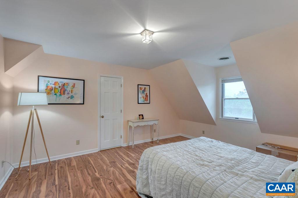 454 Pine Bluff Road Ruckersville, VA 22968 - Photo 29 of 69 a bedroom with a bed and a lamp