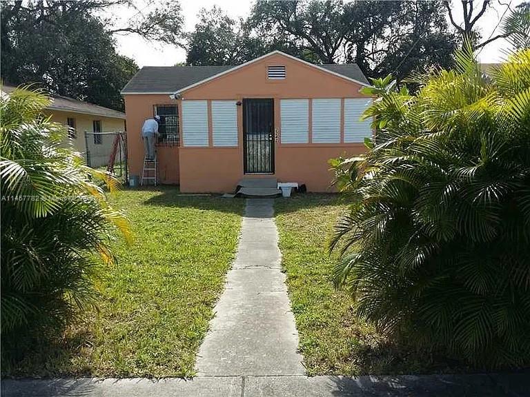 a front view of a house with garden