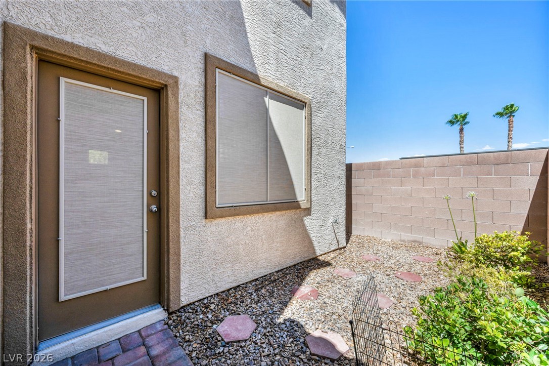 5014 Fiery Sky Ridge Street Las Vegas, NV 89148 - Photo 18 of 21 A quaint patio area offers a private outdoor retreat with a block wall and desert-friendly landscaping.