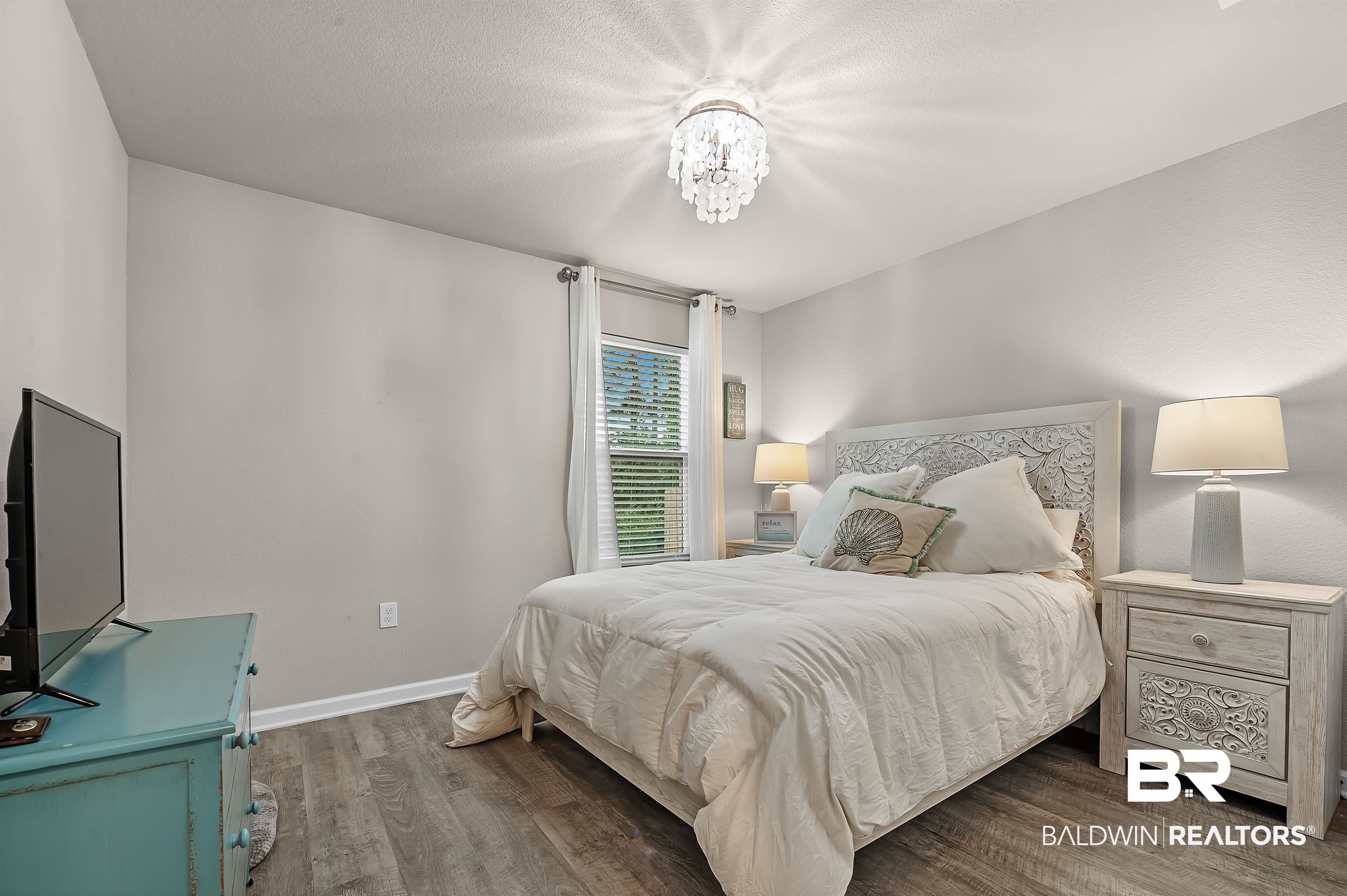 24549 Broken Sound Loop Orange Beach, AL 36561 - Photo 21 of 57 Bedroom featuring hardwood / wood-style flooring and a textured ceiling