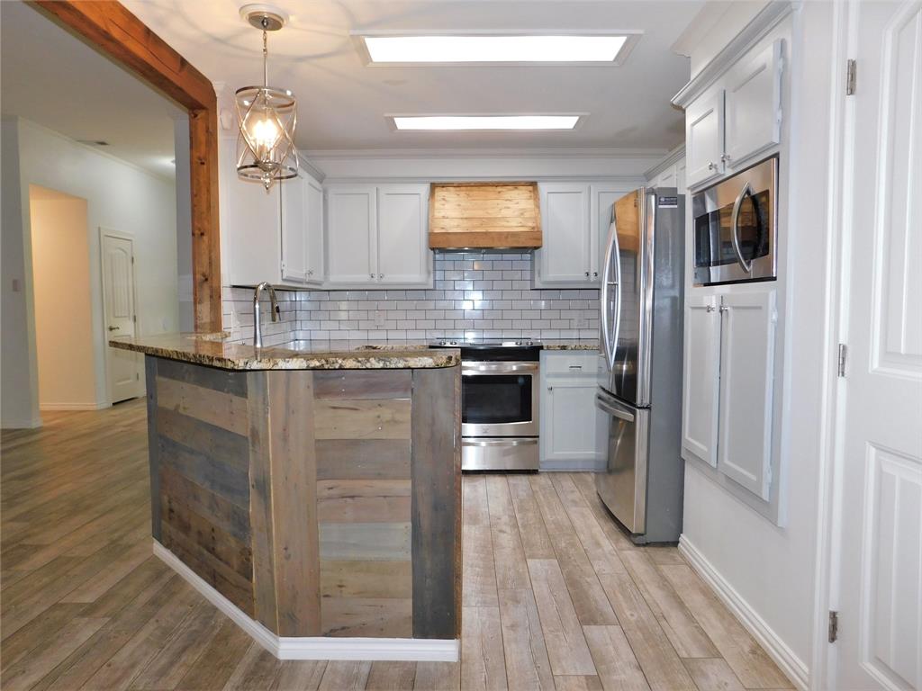 2001 Oak Tree Drive Denton, TX 76209 - Photo 12 of 34 a kitchen with stainless steel appliances granite countertop a refrigerator and a sink