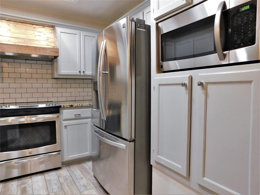 2001 Oak Tree Drive Denton, TX 76209 - Photo 14 of 34 a metallic refrigerator freezer sitting in a kitchen
