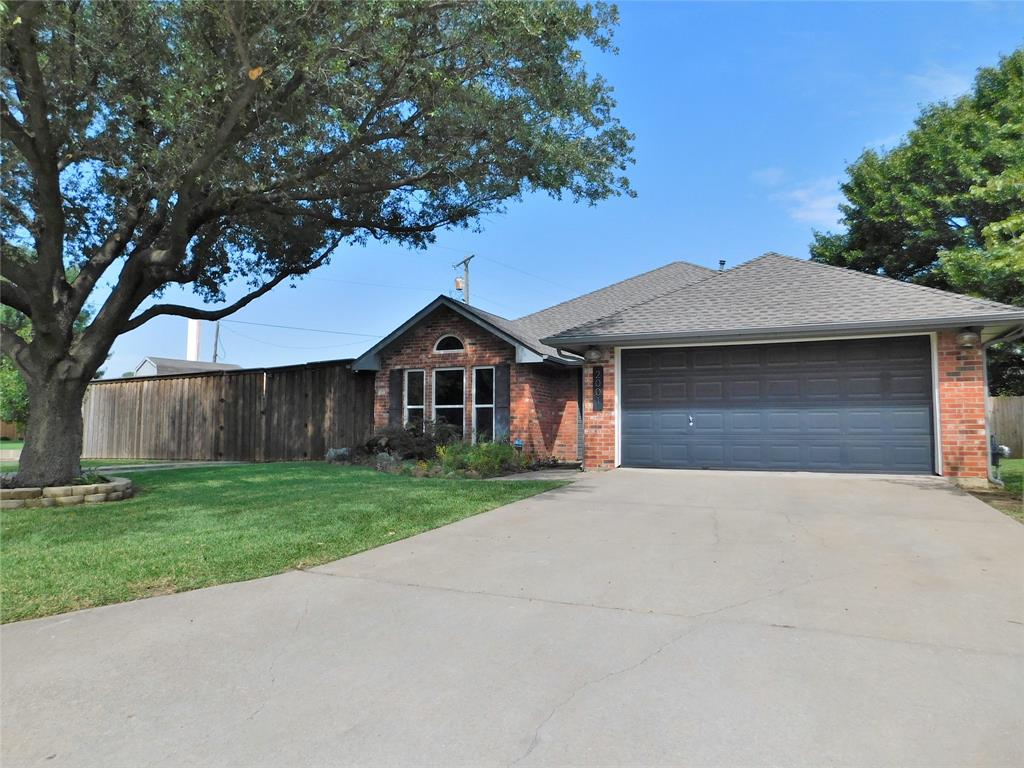 2001 Oak Tree Drive Denton, TX 76209 - Photo 2 of 34 a front view of a house with a yard and garage