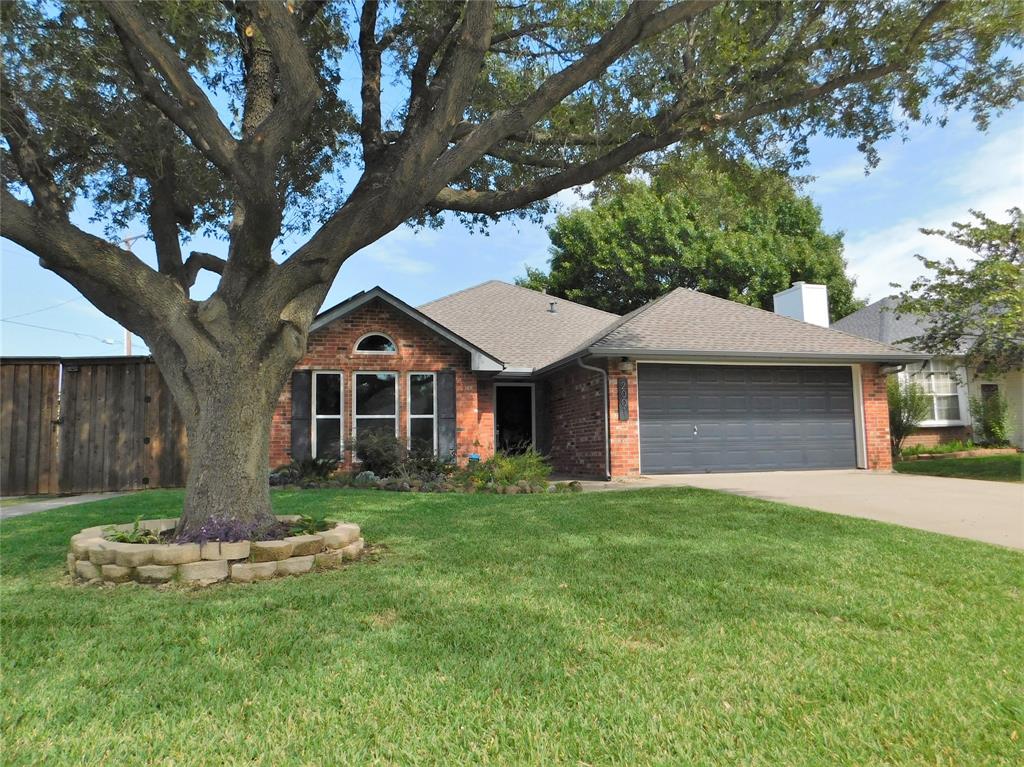 2001 Oak Tree Drive Denton, TX 76209 - Photo 3 of 34 a front view of a house with a yard and garage