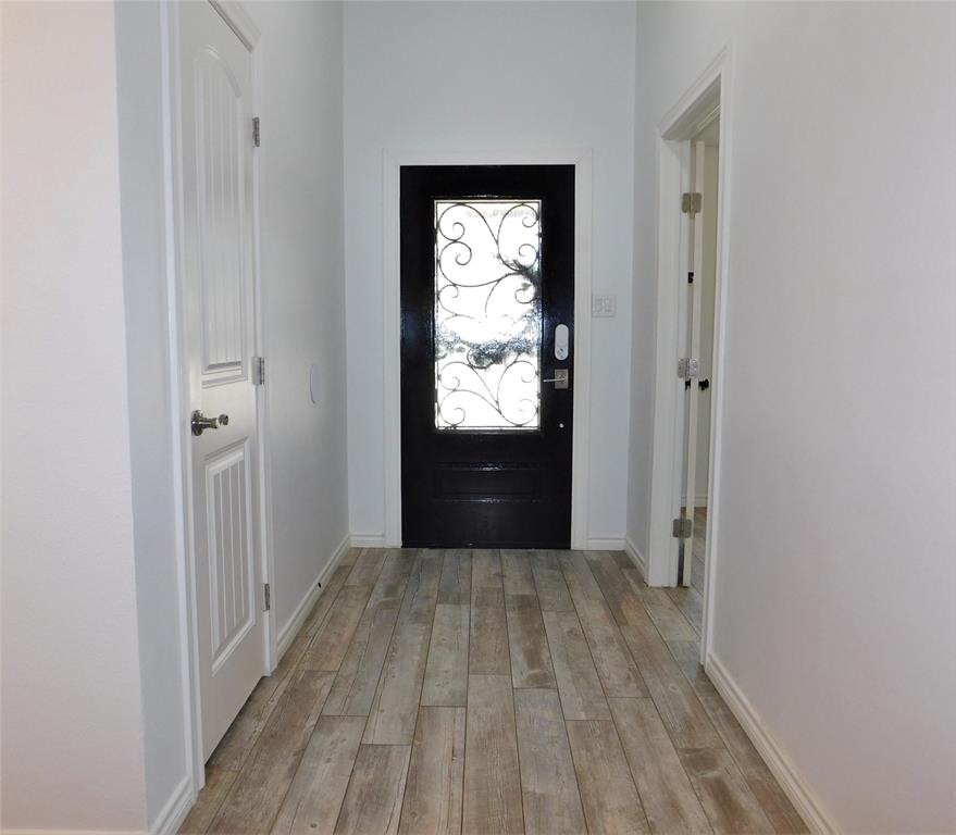 2001 Oak Tree Drive Denton, TX 76209 - Photo 8 of 34 a view of hallway with wooden floor and window