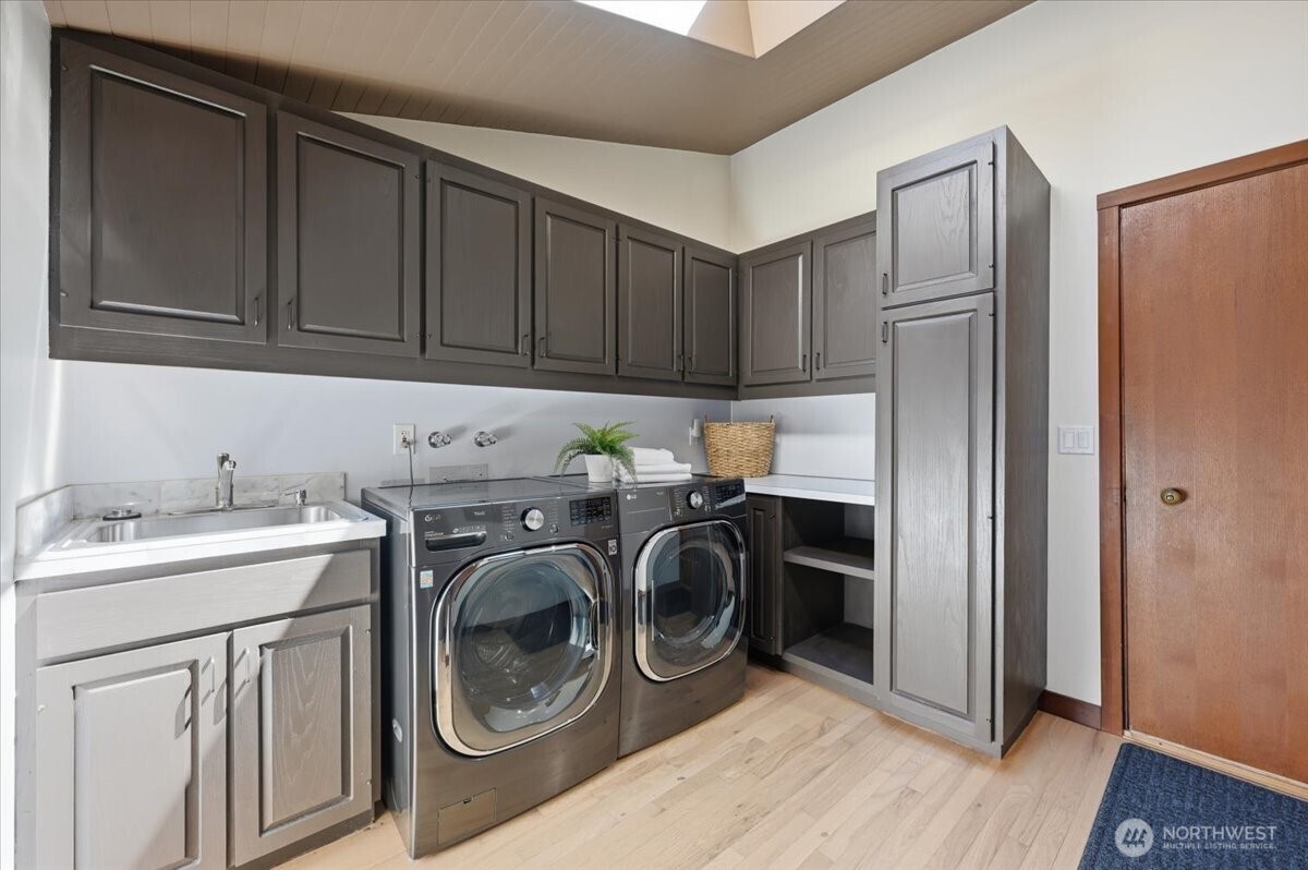 9418 Odin Way Bothell, WA 98011 - Photo 35 of 39 a utility room with sink dryer and washer
