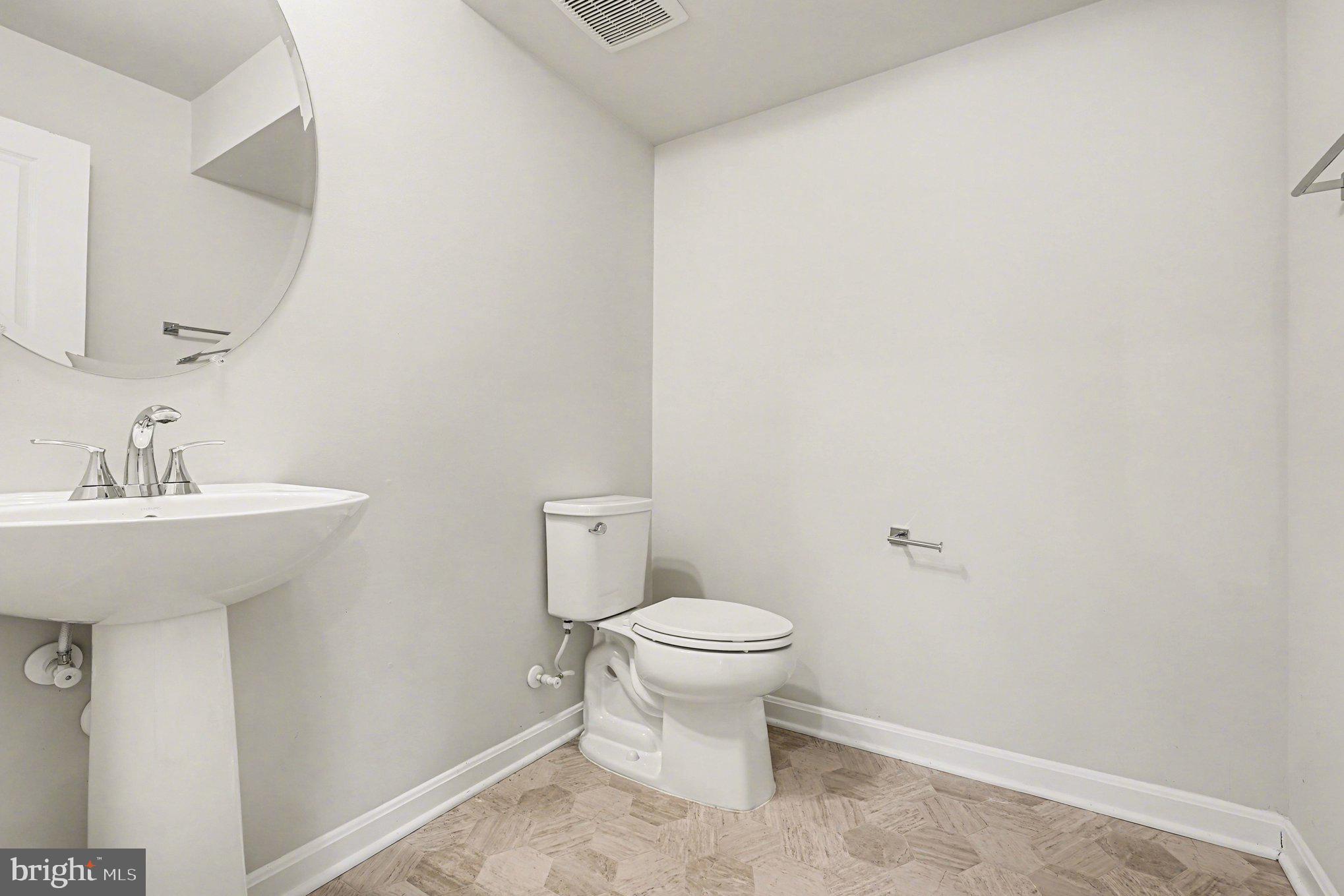 18281 Summit Pointe Drive Triangle, VA 22172 - Photo 22 of 30 a bathroom with a sink toilet and a mirror