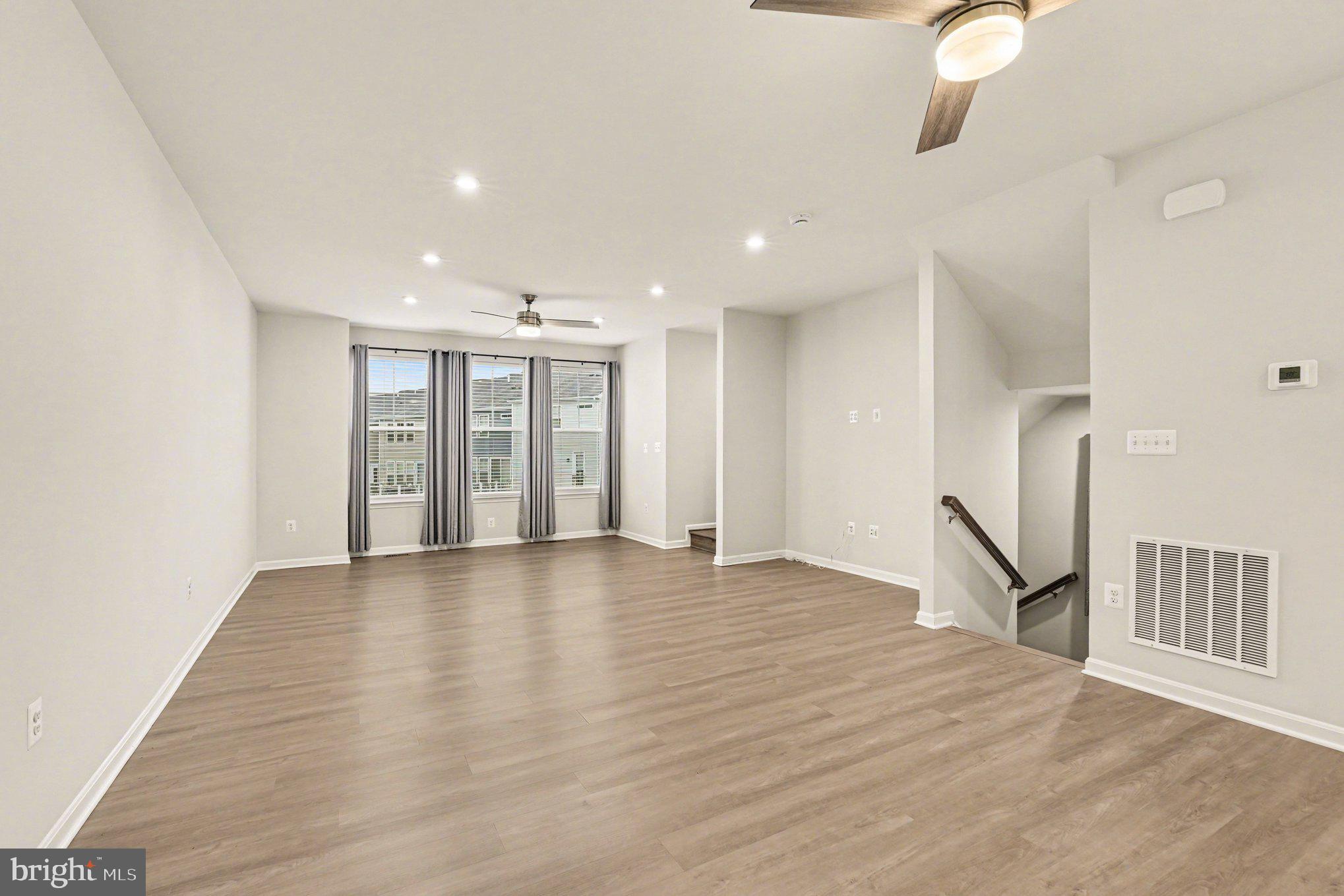 18281 Summit Pointe Drive Triangle, VA 22172 - Photo 4 of 30 a view of an empty room with wooden floor and a window
