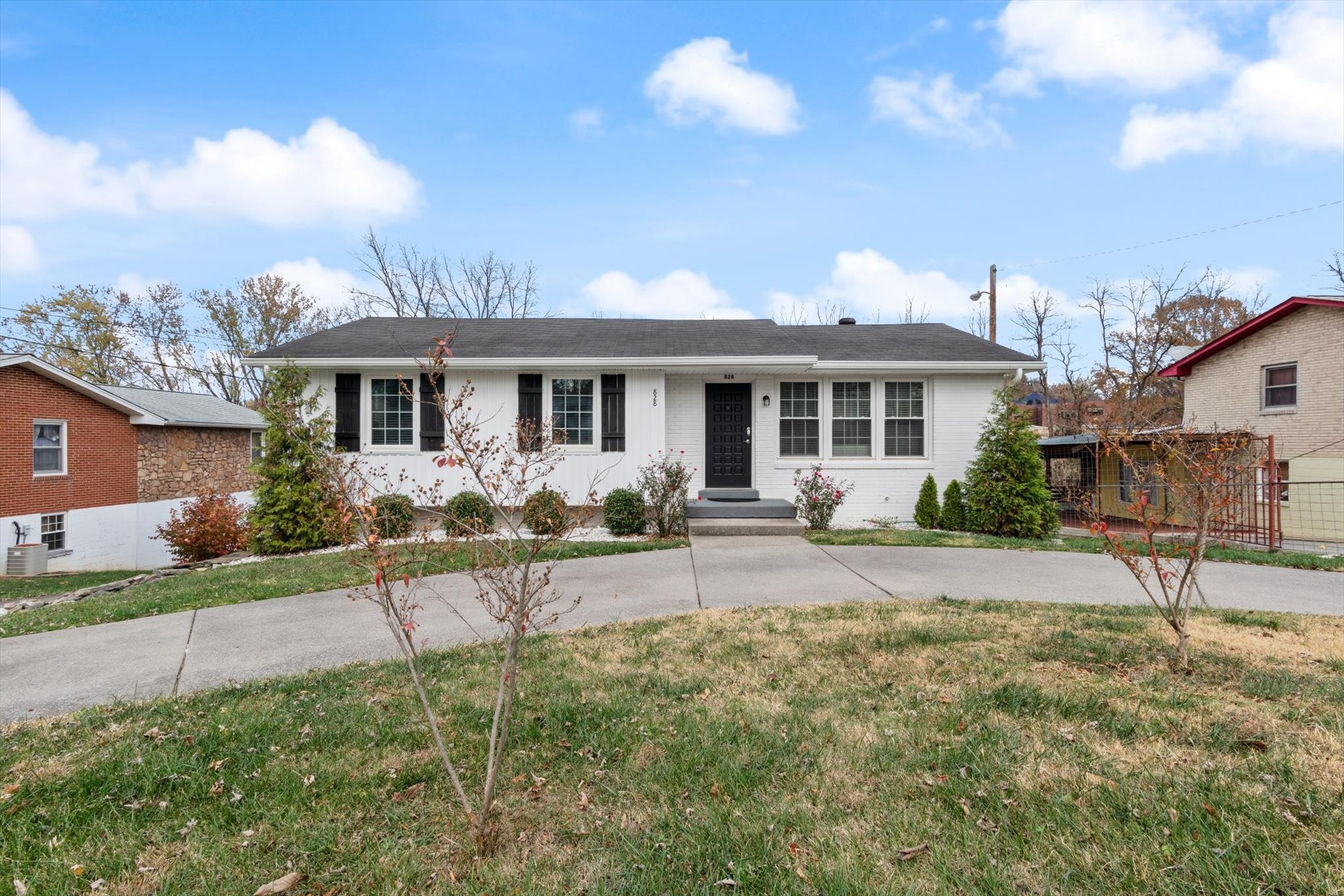 a view of a house with backyard and sitting area