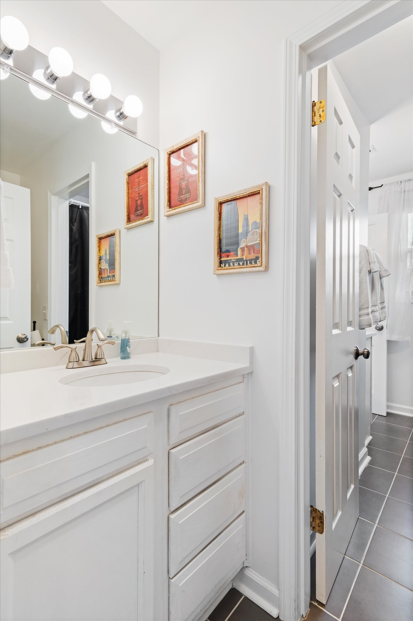 828 Irma Drive Antioch, TN 37013 - Photo 13 of 23 a bathroom with a sink and a mirror