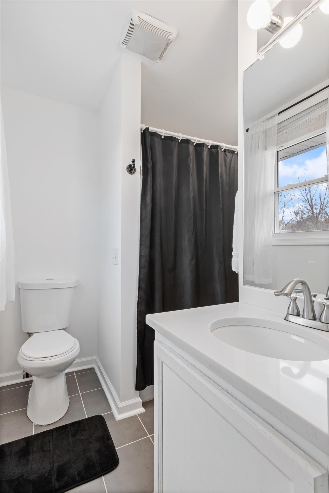 828 Irma Drive Antioch, TN 37013 - Photo 15 of 23 a bathroom with a sink a toilet and a mirror
