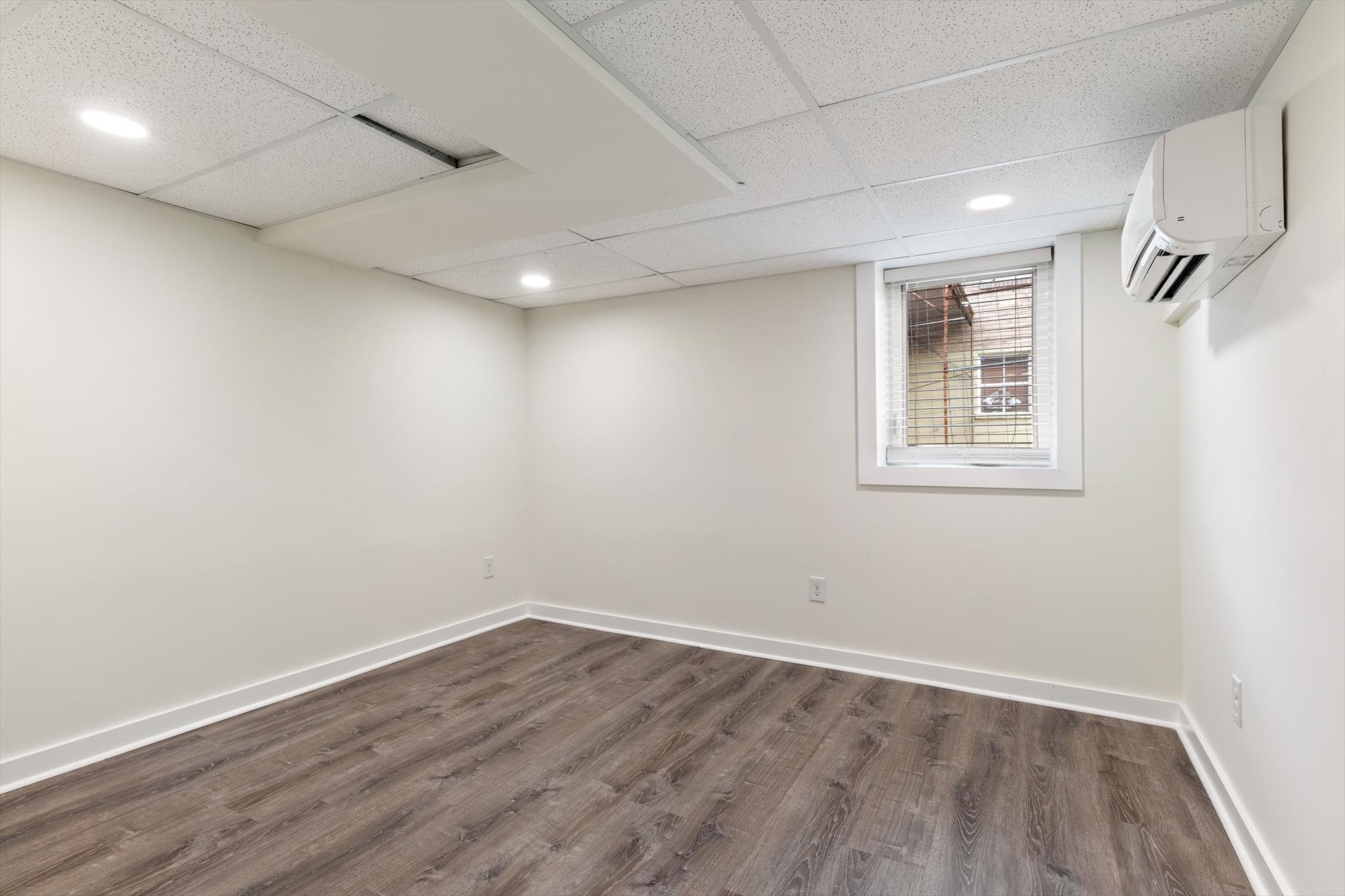 828 Irma Drive Antioch, TN 37013 - Photo 23 of 23 an empty room with wooden floor and windows