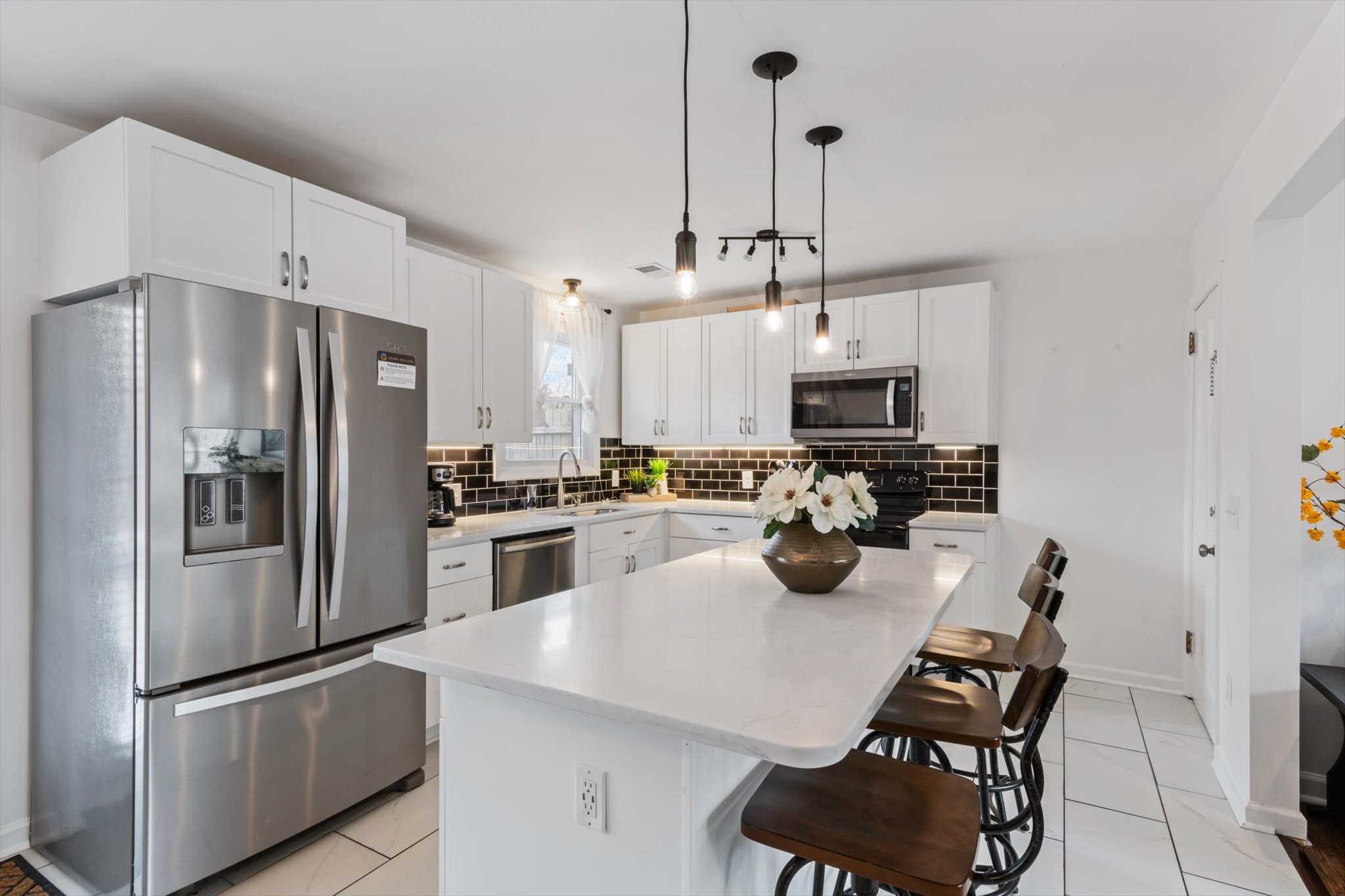 828 Irma Drive Antioch, TN 37013 - Photo 9 of 23 a kitchen with stainless steel appliances granite countertop a stove refrigerator and microwave