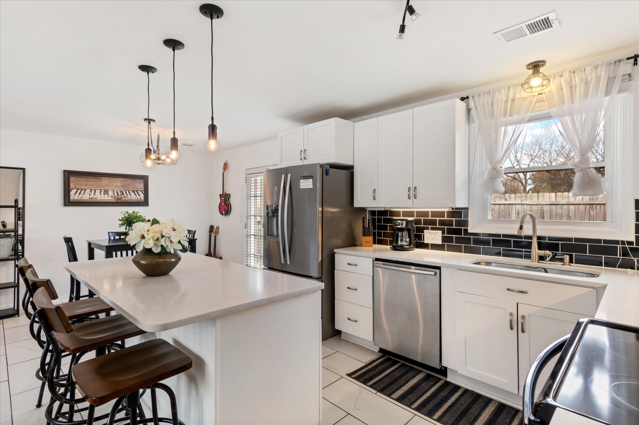 828 Irma Drive Antioch, TN 37013 - Photo 10 of 23 a kitchen with stainless steel appliances a refrigerator a sink a stove a dining table and chairs