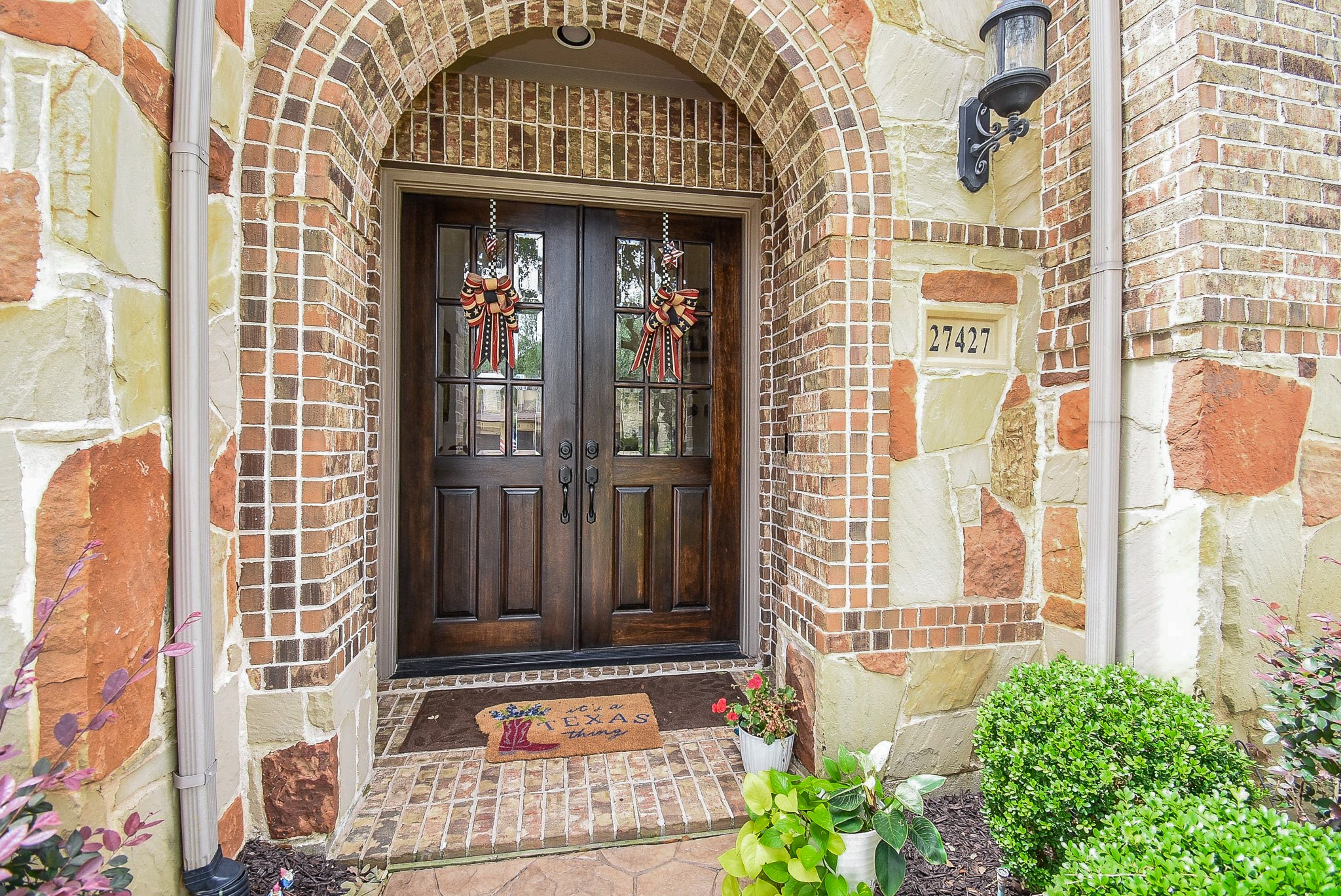 27427 Guthrie Ridge Lane Katy, TX 77494 - Photo 5 of 48 a view of a brick building with a large door