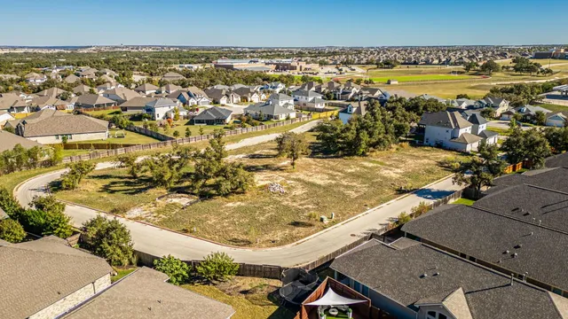 an aerial view of a swimming pool with outdoor seating
