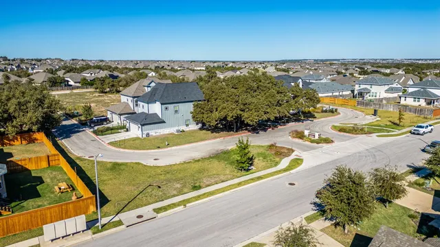 an aerial view of a house with a swimming pool