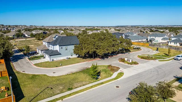 an aerial view of a house with a swimming pool