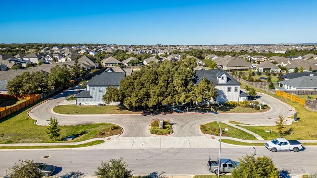 an aerial view of a house with a swimming pool