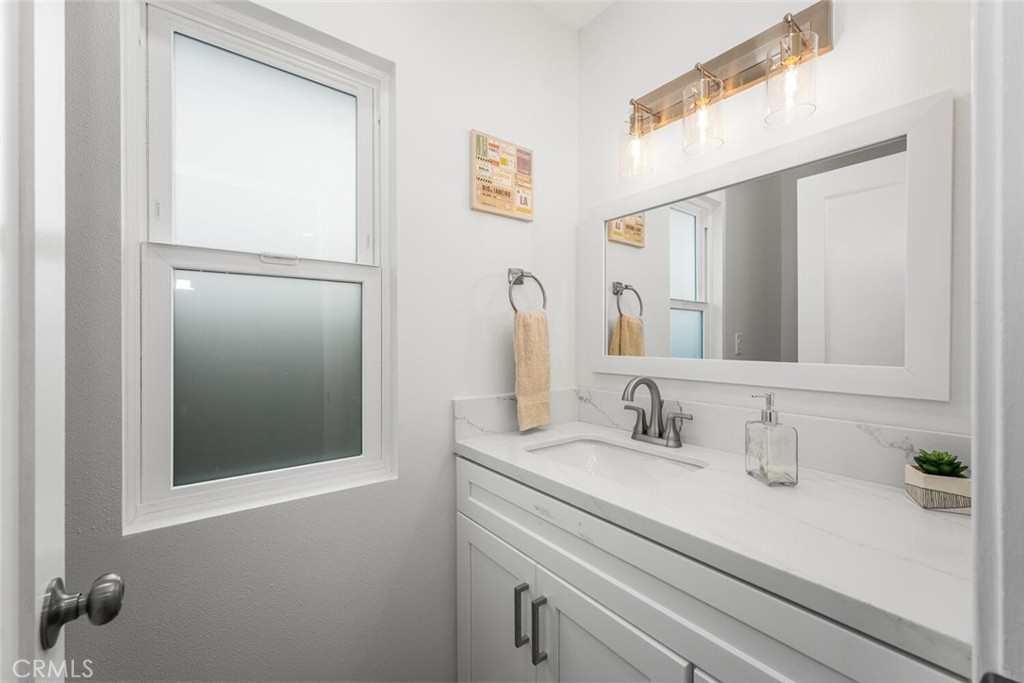 11344 Rochelle Street Los Alamitos, CA 90720 - Photo 18 of 55 a bathroom with a sink and a mirror