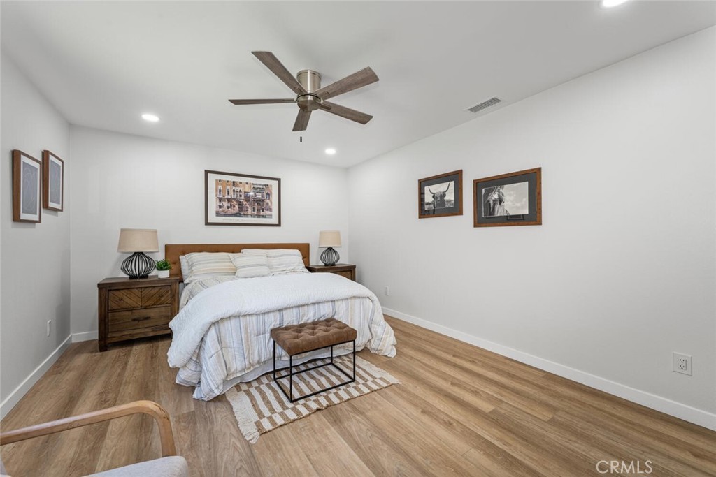 11344 Rochelle Street Los Alamitos, CA 90720 - Photo 20 of 55 a bedroom with a large bed and a chandelier