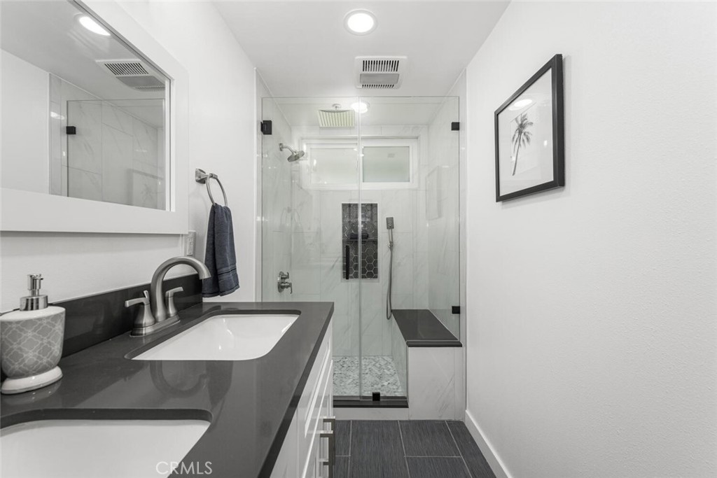 11344 Rochelle Street Los Alamitos, CA 90720 - Photo 25 of 55 a bathroom with double vanity sink and mirror