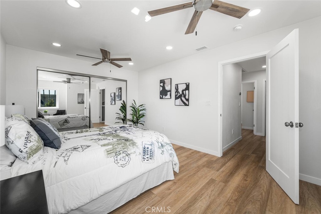 11344 Rochelle Street Los Alamitos, CA 90720 - Photo 30 of 55 a spacious bedroom with a bed and a chandelier