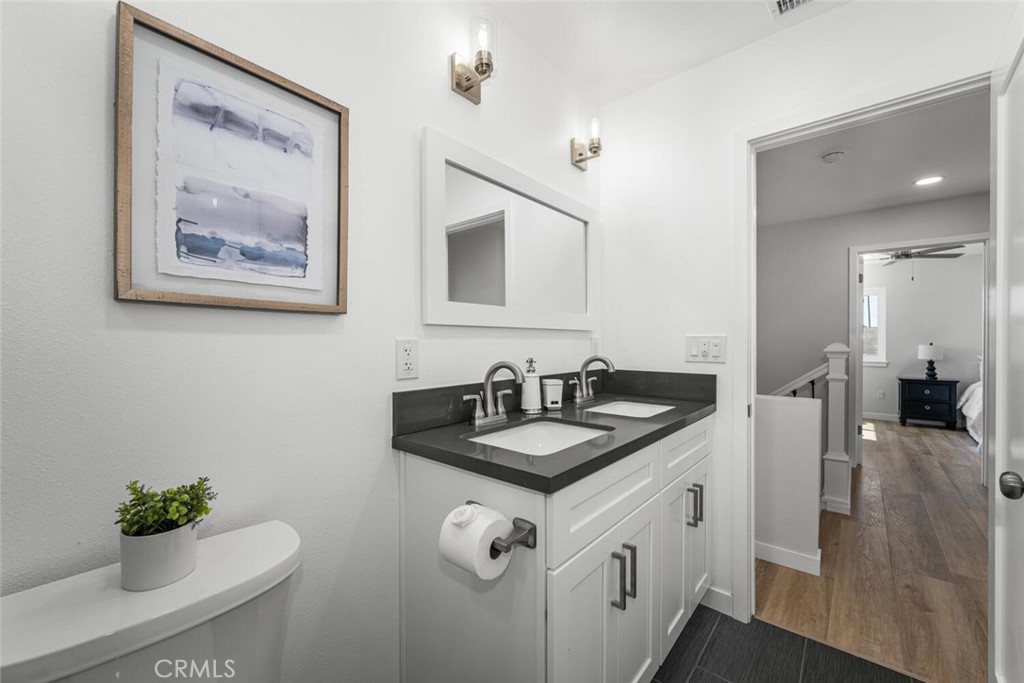 11344 Rochelle Street Los Alamitos, CA 90720 - Photo 33 of 55 a bathroom with a granite countertop sink a mirror and a