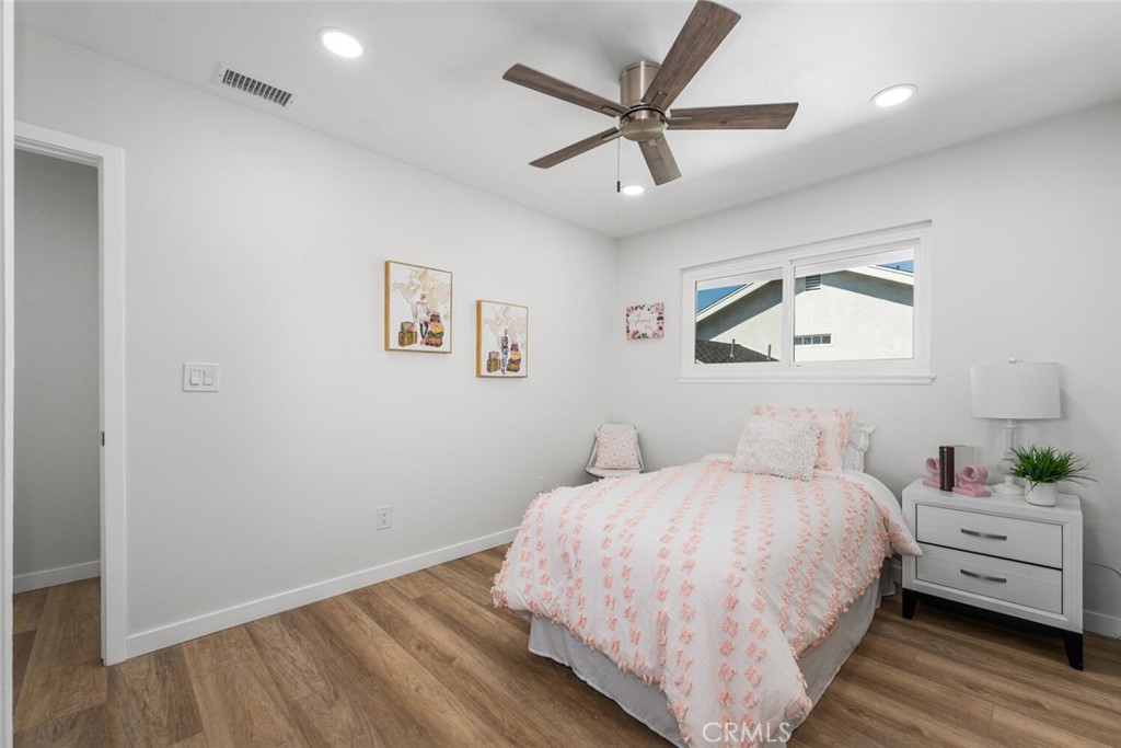 11344 Rochelle Street Los Alamitos, CA 90720 - Photo 35 of 55 a bedroom with a large bed a chandelier and a window