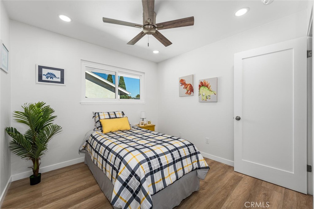 11344 Rochelle Street Los Alamitos, CA 90720 - Photo 38 of 55 a bedroom with a bed a painting on the wall and a potted plant