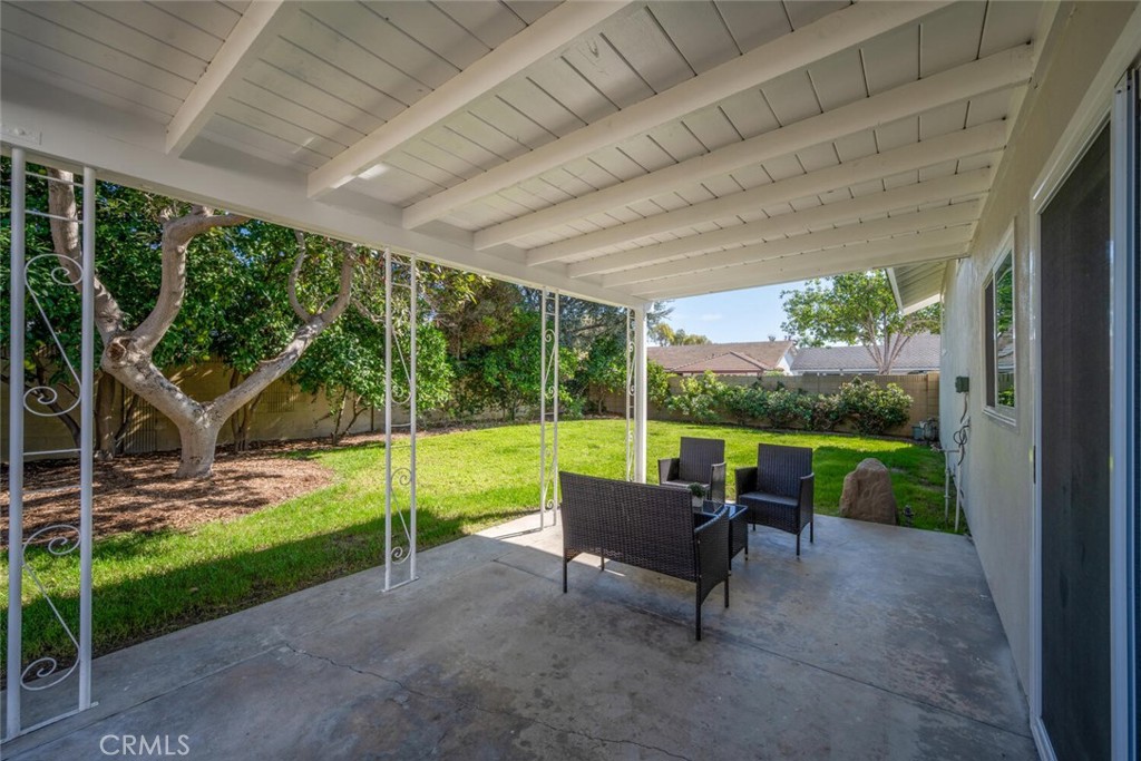 11344 Rochelle Street Los Alamitos, CA 90720 - Photo 42 of 55 a view of a patio with table and chairs potted plants with wooden floor and fence