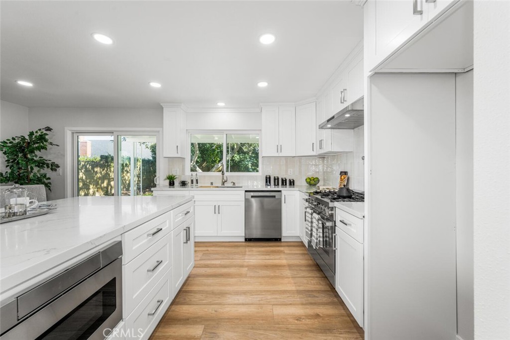 11344 Rochelle Street Los Alamitos, CA 90720 - Photo 10 of 55 a kitchen with white cabinets stove and sink