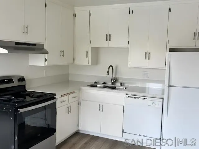 229-45 Shady Lane El Cajon, CA 92021 - Photo 47 of 65 a kitchen with granite countertop white cabinets and white appliances