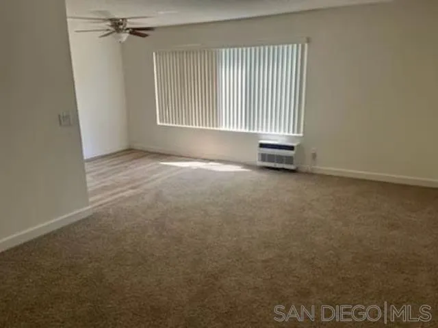 229-45 Shady Lane El Cajon, CA 92021 - Photo 48 of 65 an empty room with a exposed radiator and window