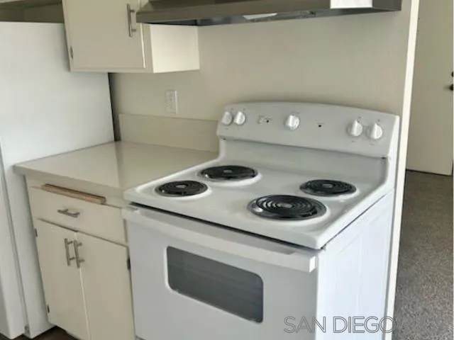 229-45 Shady Lane El Cajon, CA 92021 - Photo 51 of 65 a kitchen with a stove and a refrigerator