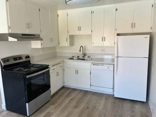 229-45 Shady Lane El Cajon, CA 92021 - Photo 55 of 65 a kitchen with cabinets appliances and wooden floor