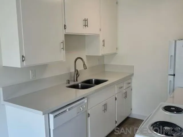 229-45 Shady Lane El Cajon, CA 92021 - Photo 64 of 65 a kitchen with sink a stove and cabinets